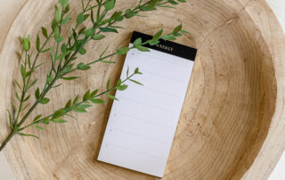 To-do list and a sprig of a plant